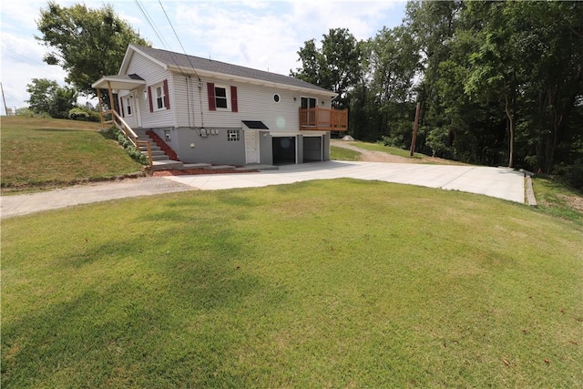 view of front of house with concrete driveway, a front lawn, a garage, a wooden deck, and stairs