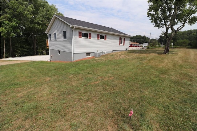 exterior space with a lawn and cooling unit