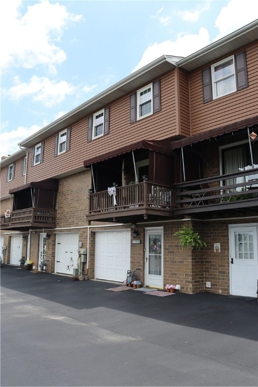 view of front of house featuring a balcony and a garage