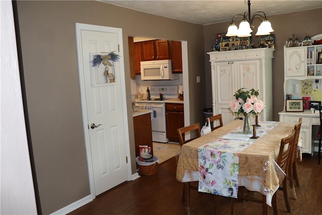 dining room featuring an inviting chandelier and hardwood / wood-style flooring