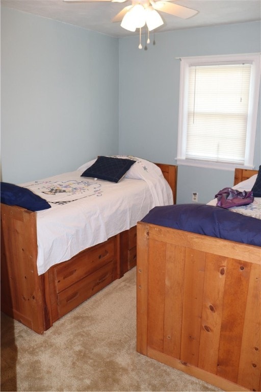 bedroom featuring light colored carpet and ceiling fan