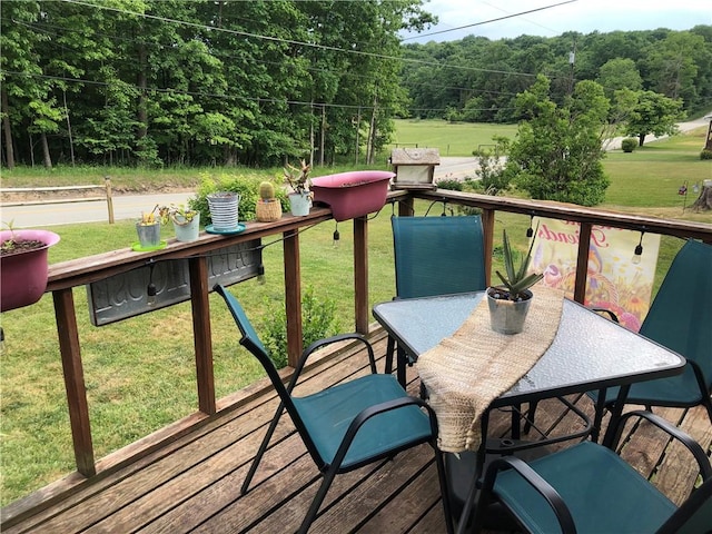 wooden terrace with a lawn