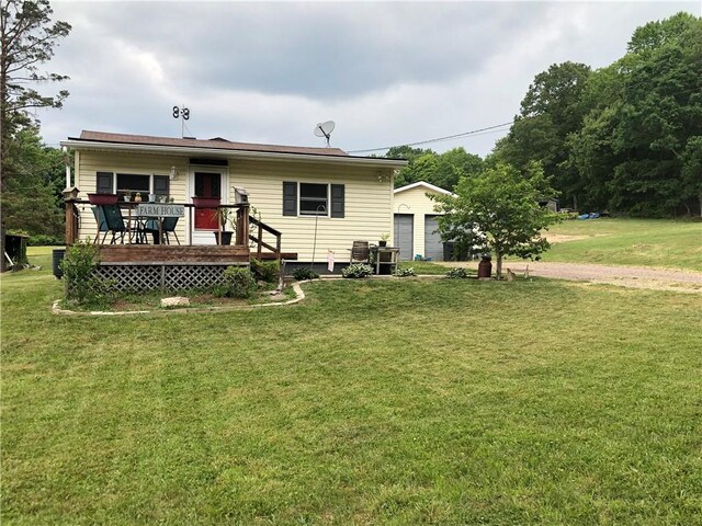 rear view of property with a deck and a yard