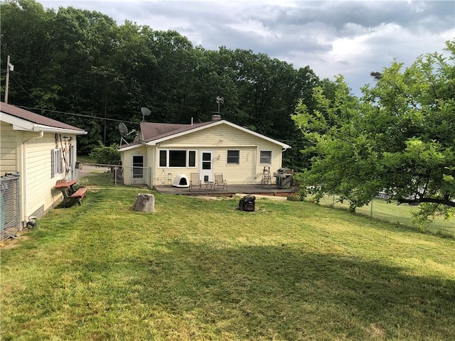 back of house with a wooden deck, ac unit, and a lawn