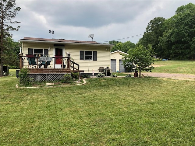 rear view of house with a yard and a deck