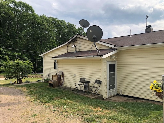 back of house with a lawn