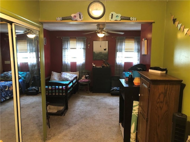 bedroom with multiple windows and light colored carpet