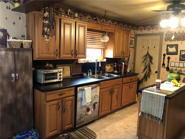 kitchen featuring pendant lighting, ceiling fan, dishwasher, and sink