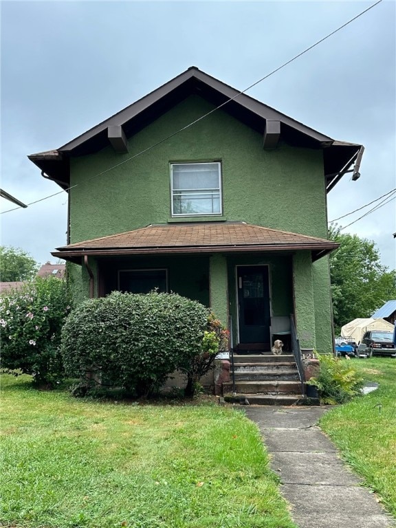 bungalow-style home with a front yard