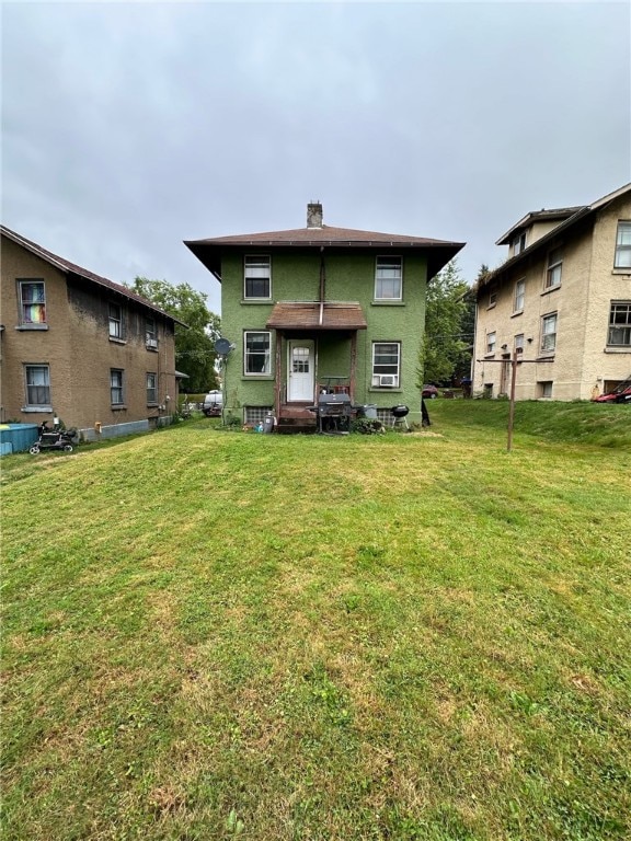 rear view of property featuring a yard