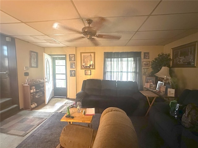 living room featuring a paneled ceiling, plenty of natural light, carpet, and ceiling fan