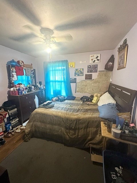 bedroom with a textured ceiling and ceiling fan