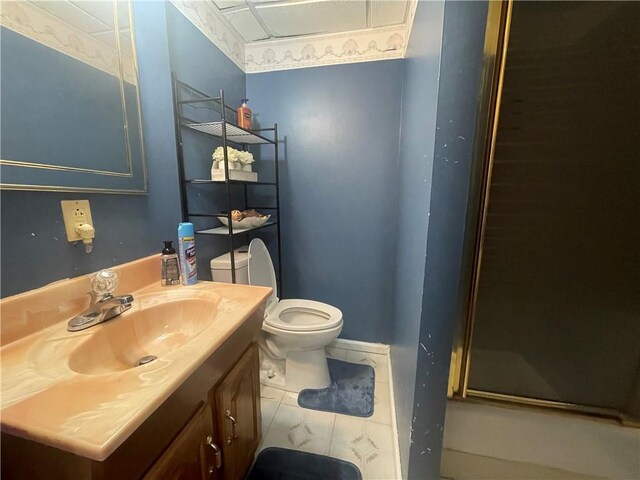 bathroom with tile patterned flooring, toilet, and vanity