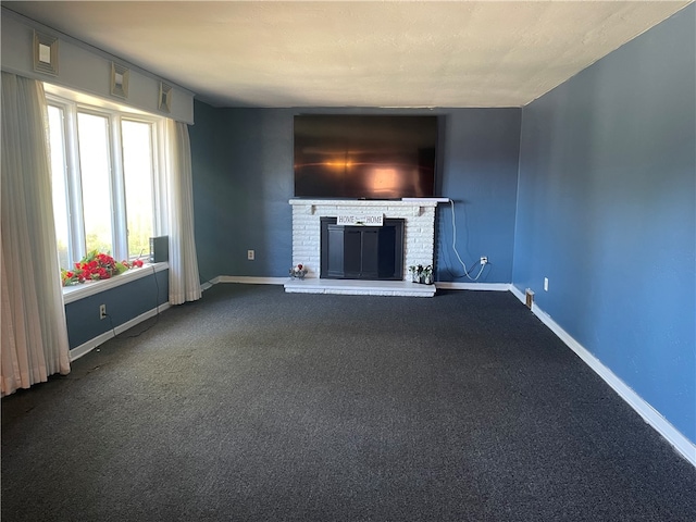 unfurnished living room featuring carpet flooring and a brick fireplace