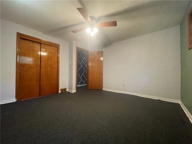 unfurnished bedroom with carpet, a closet, and ceiling fan