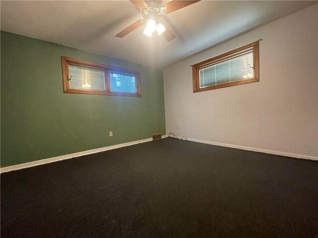 carpeted spare room with ceiling fan