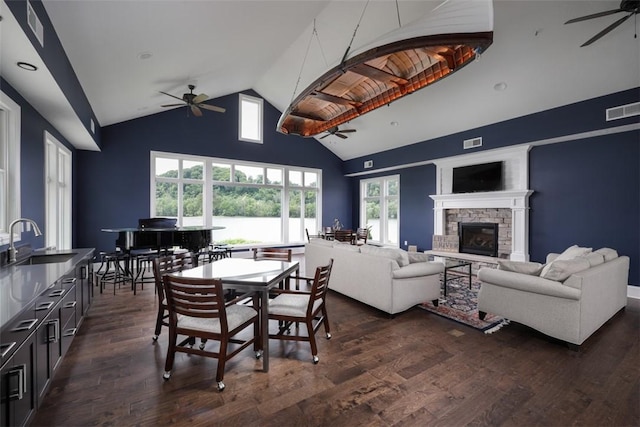 dining space with dark hardwood / wood-style floors, a healthy amount of sunlight, and sink