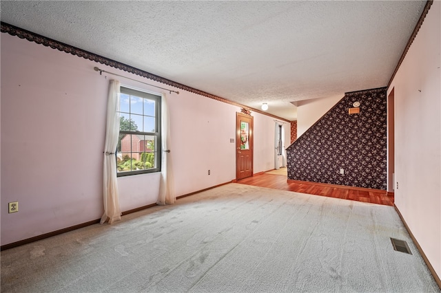 interior space featuring a textured ceiling and light hardwood / wood-style flooring