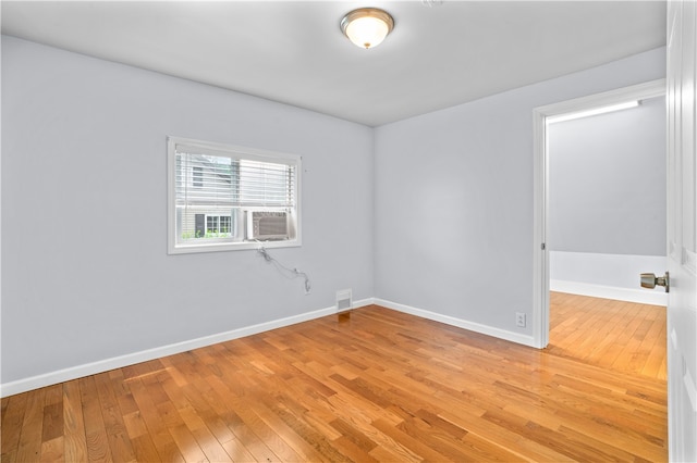 empty room with hardwood / wood-style floors