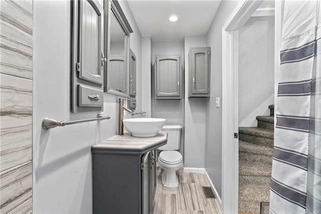 bathroom featuring hardwood / wood-style floors, vanity, and toilet