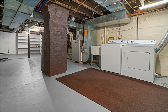 basement with heating unit and washer and dryer