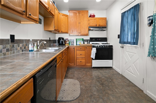 kitchen with dishwasher, sink, dark tile patterned flooring, tile counters, and white gas stove