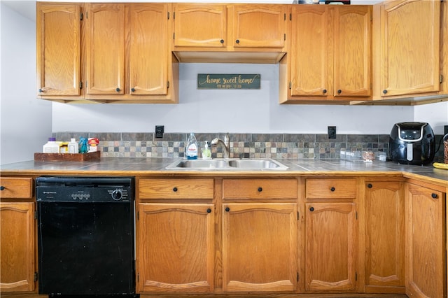 kitchen featuring sink, dishwasher, and tasteful backsplash