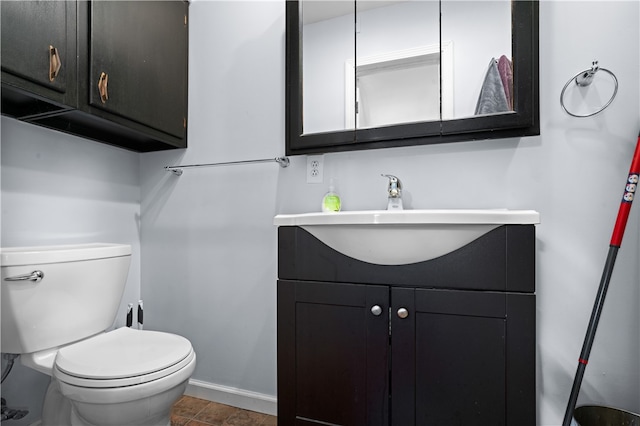 bathroom with tile patterned floors, vanity, and toilet