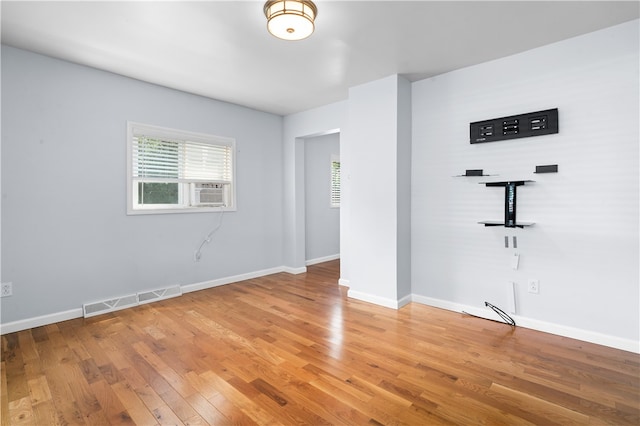 spare room with wood-type flooring and cooling unit