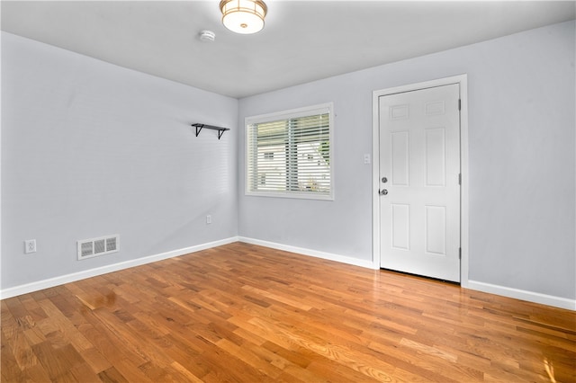 spare room with hardwood / wood-style flooring