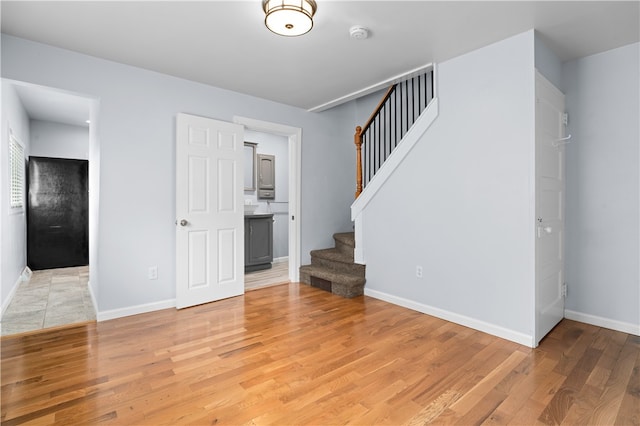 unfurnished living room with wood-type flooring