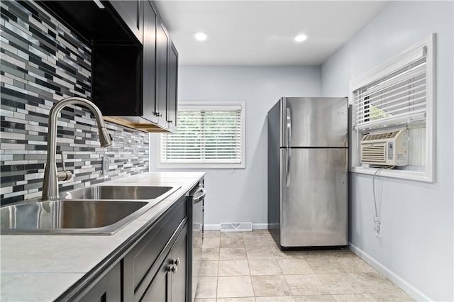 kitchen featuring tasteful backsplash, stainless steel appliances, cooling unit, sink, and light tile patterned floors