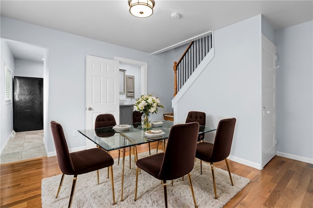 dining space with hardwood / wood-style flooring