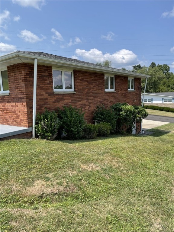 view of home's exterior with a lawn