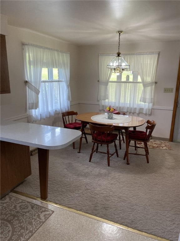 142 Greenridge Dr, Carroll Twp, PA 15063 - carpeted dining area with a chandelier