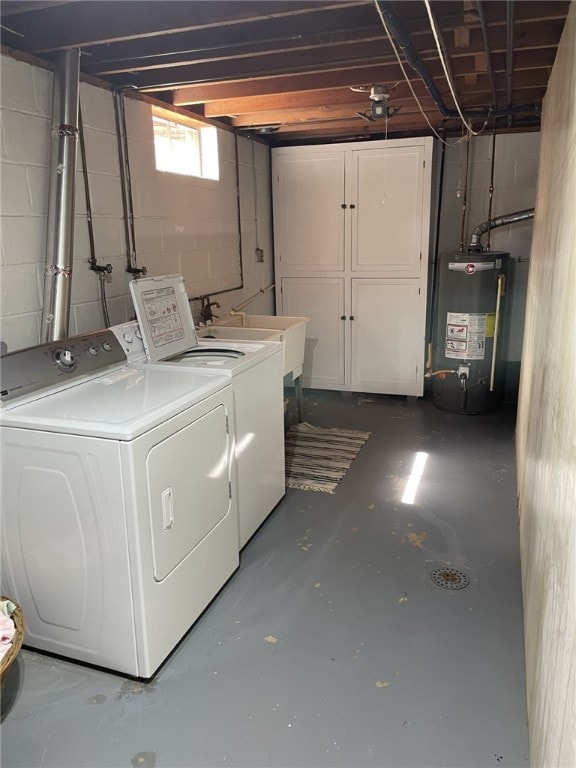 washroom featuring sink, washing machine and dryer, and gas water heater