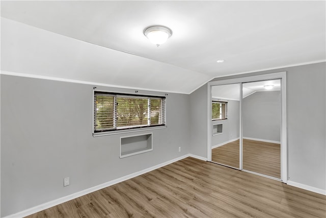 bonus room featuring lofted ceiling and light wood-type flooring