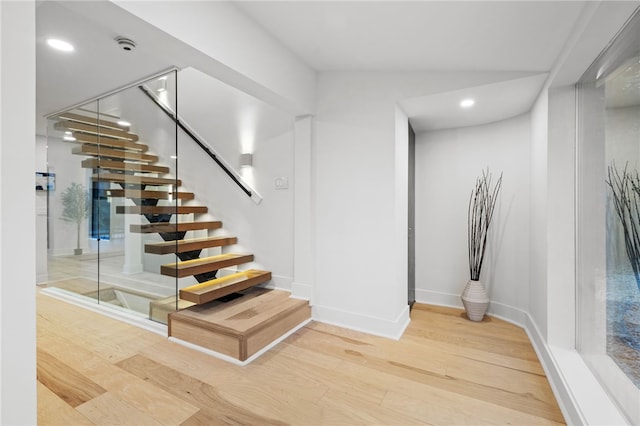 stairs featuring hardwood / wood-style floors