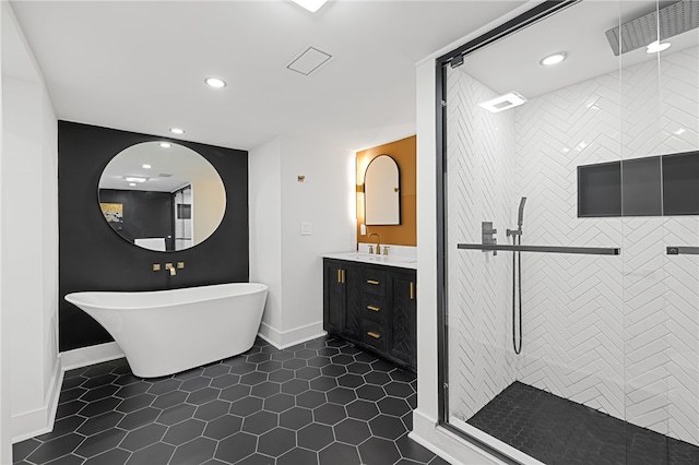 bathroom featuring shower with separate bathtub, tile patterned floors, and vanity