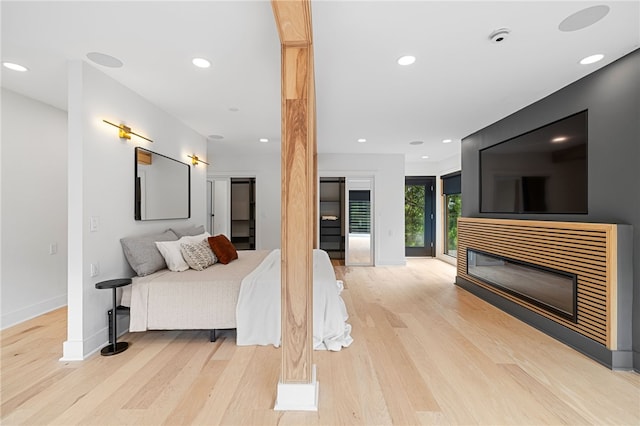 bedroom with access to exterior and light wood-type flooring