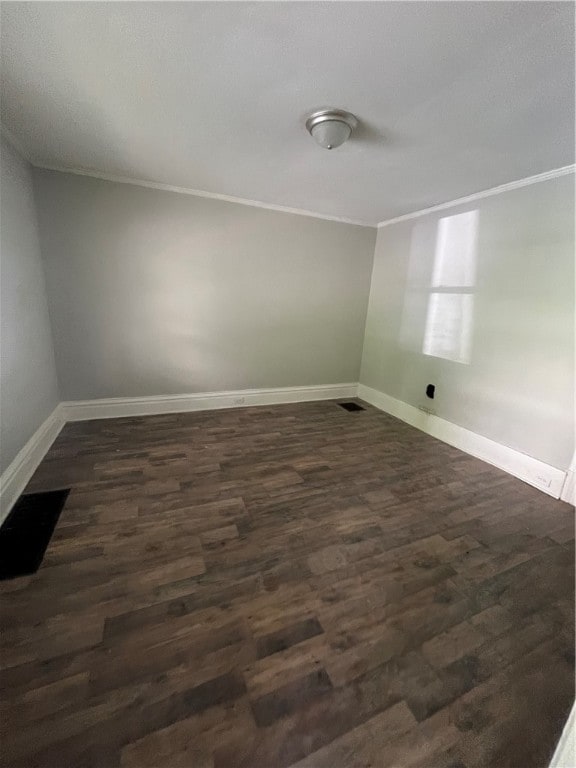 unfurnished room with dark wood-type flooring and ornamental molding