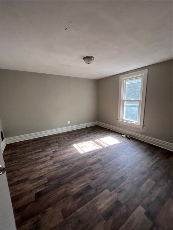 spare room featuring dark hardwood / wood-style flooring