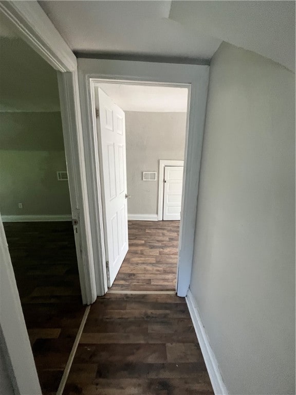 hall with dark wood-type flooring