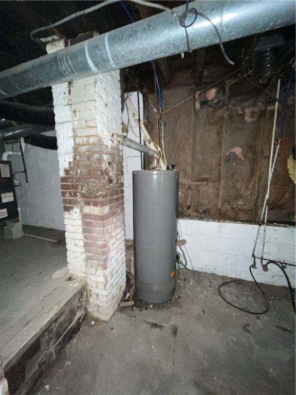 basement with brick wall and gas water heater