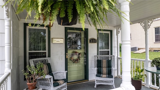 view of exterior entry featuring covered porch