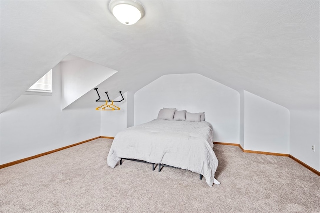 carpeted bedroom featuring lofted ceiling