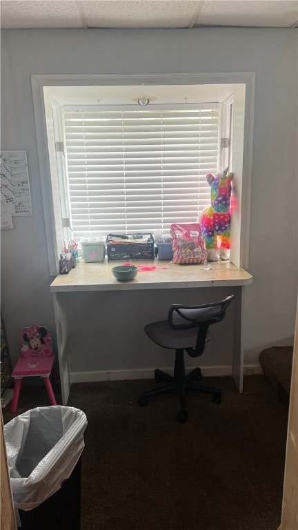 carpeted home office featuring a drop ceiling