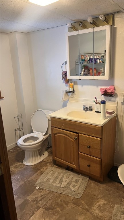 bathroom featuring tile patterned flooring, toilet, and vanity