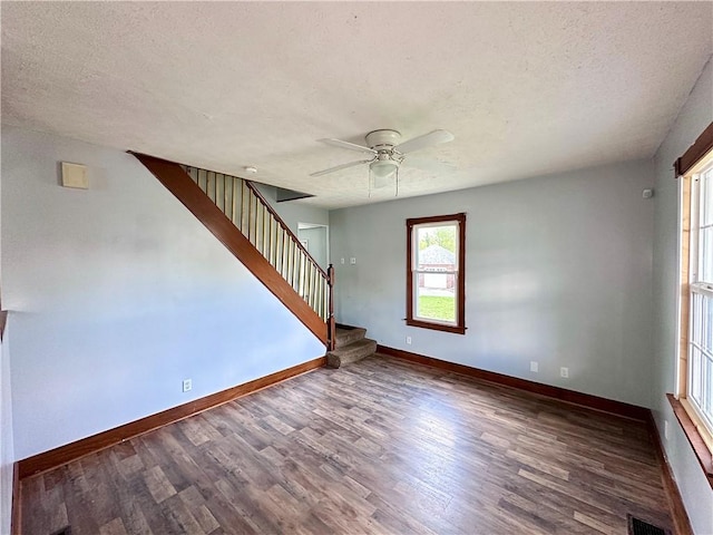 118 Wengler Ave, Sharon, PA 16146 - unfurnished living room with wood finished floors, baseboards, ceiling fan, stairway, and a textured ceiling