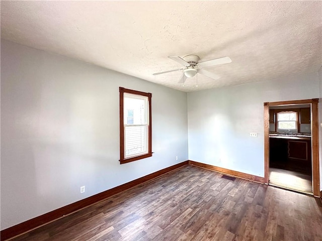 118 Wengler Ave, Sharon, PA 16146 - spare room featuring a ceiling fan, baseboards, dark wood finished floors, and a textured ceiling